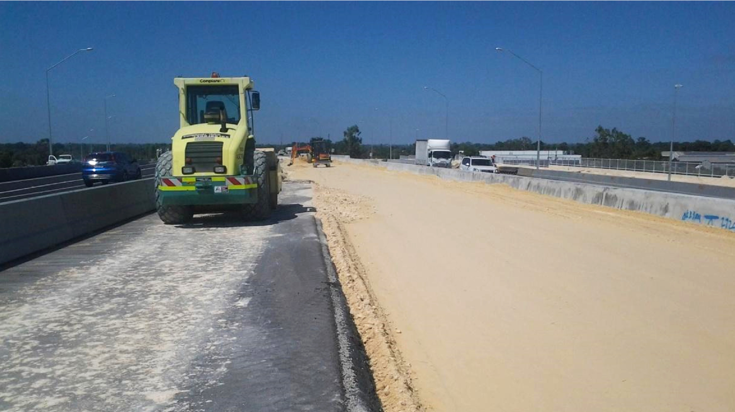 Roe Highway Duplication A photograph of the Roe Highway Duplication construction infrastructure project. Specifically a digger providing along the leveled surface.