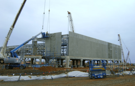 This is a photograph of the construction of the Pluto LNG Plant underway through the use of cranes and large scale scaffolding.
