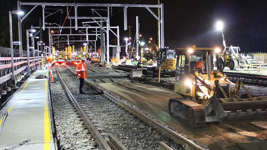 This photograph is of Monford Group employees completing a major infrastructure project. Using state of the art machinery to complete the train tracks on time under every condition even at night.
