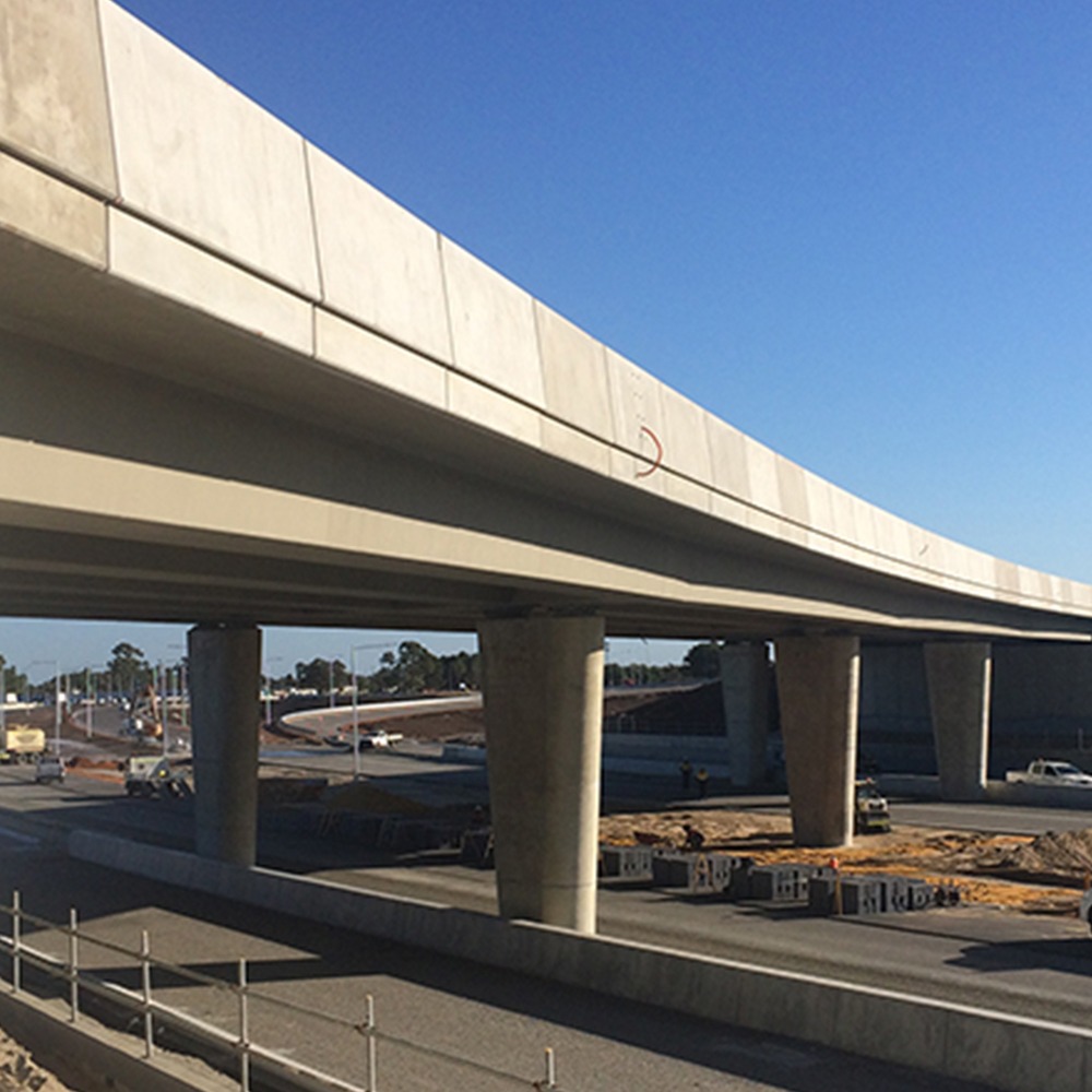 The photograph is of a newly built cement overpass completed by Monford that stretches across the freeway.