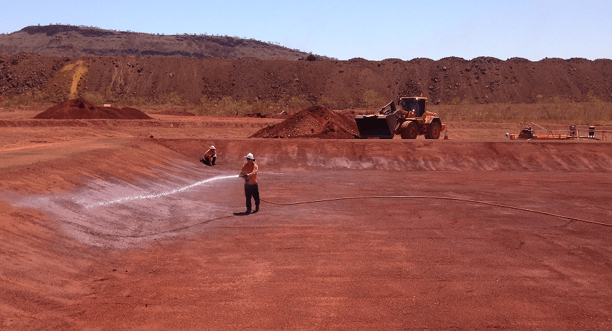This photograph was taken inside the pit of the mine and shows workers wetting the soil in the area to aid works. Safety is the main concern and PPE is always used to minimize risk.